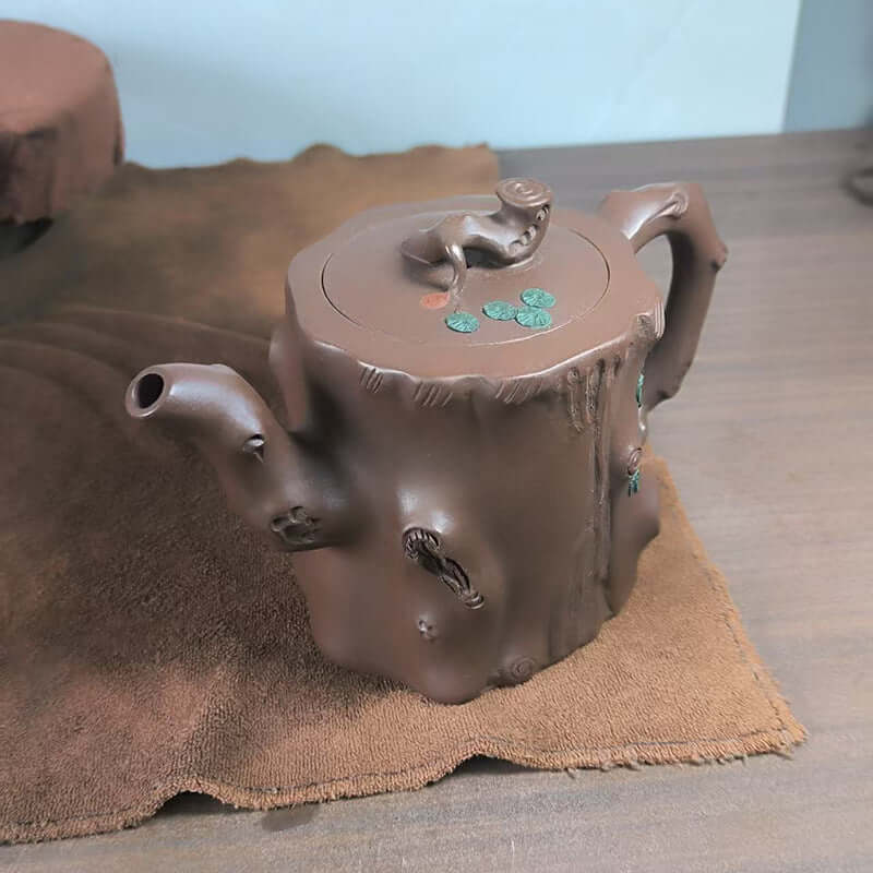 Handmade Yixing purple sand teapot designed as a tree stump, showcasing original purple sand craftsmanship.