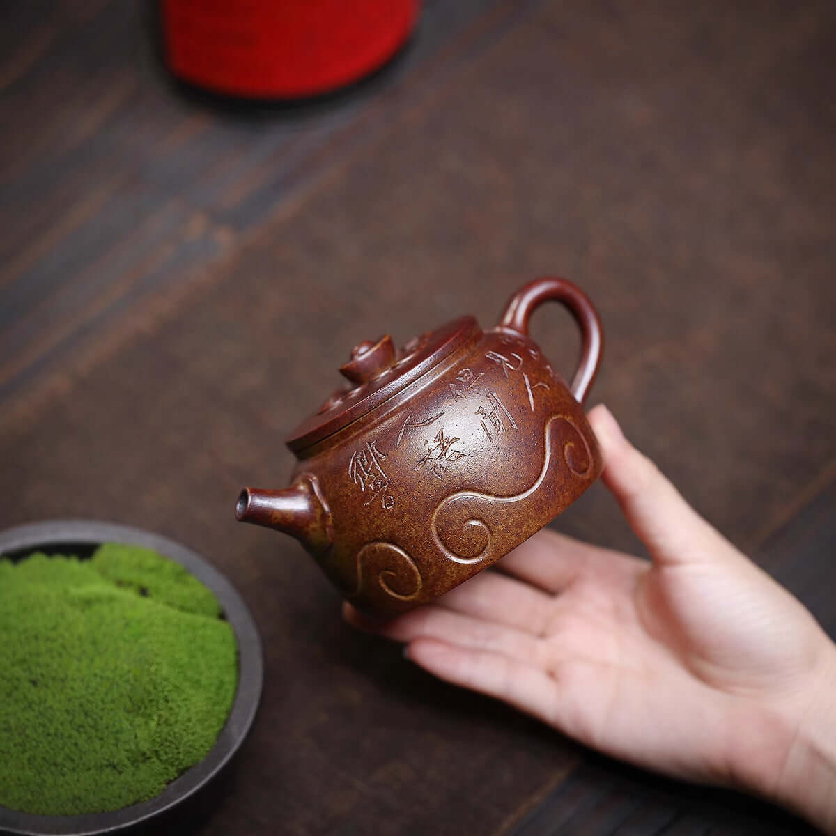 Handmade Yixing purple sand teapot with intricate designs, ideal for tea enthusiasts and collectors.