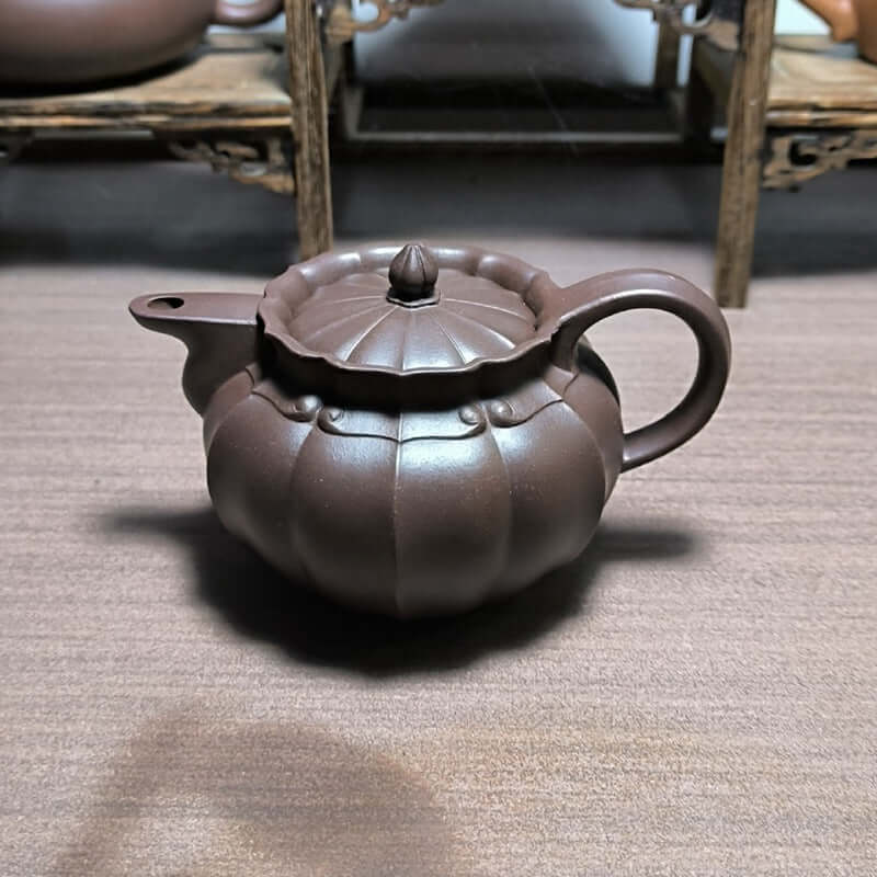Handmade Yixing purple sand teapot, featuring a unique pumpkin design and original purple clay craftsmanship.