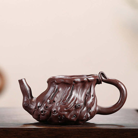 Handcrafted Yixing purple sand teapot with a unique organic shape, showcasing expert artistry and traditional design.