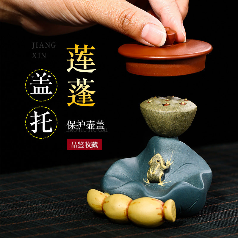 Handmade Yixing purple sand frog decoration with lotus leaf pot holder for tea set presentation.