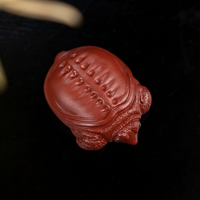 Handmade Yixing purple sand tea pet ornament in turtle shape, perfect for tea lovers and collectors.