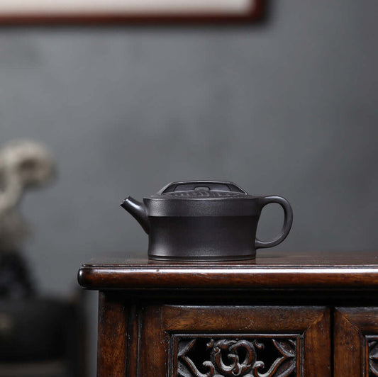 Handmade Yixing purple sand teapot on wooden table, showcasing original mineral clay craftsmanship.