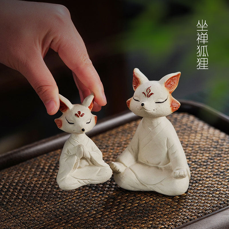 Handmade Yixing purple sand tea pet fox sculptures, perfect for tea tables and Zen decor, showcasing craftsmanship and creativity.