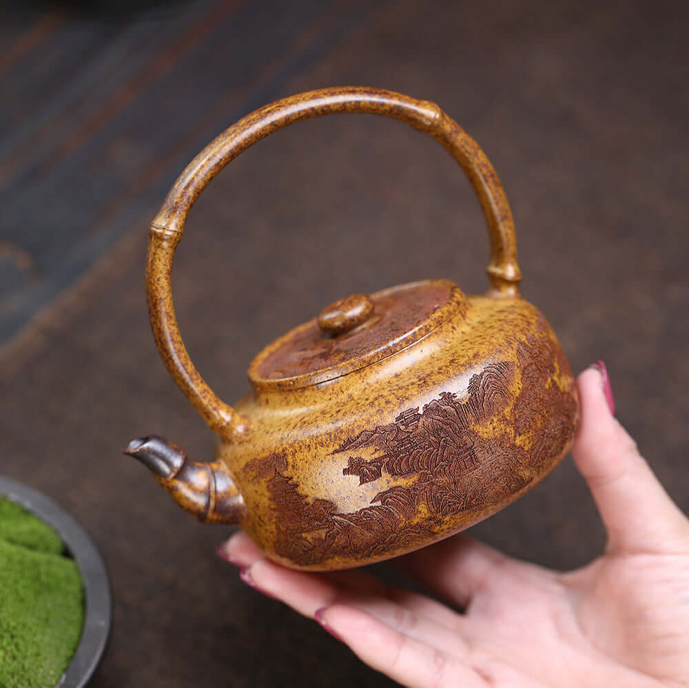 Handmade Yixing purple sand teapot showcasing mountain scenery, perfect for home kung fu tea set.