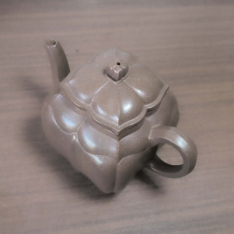 Handmade Yixing purple sand teapot with unique design, crafted from original purple sand for tea lovers.