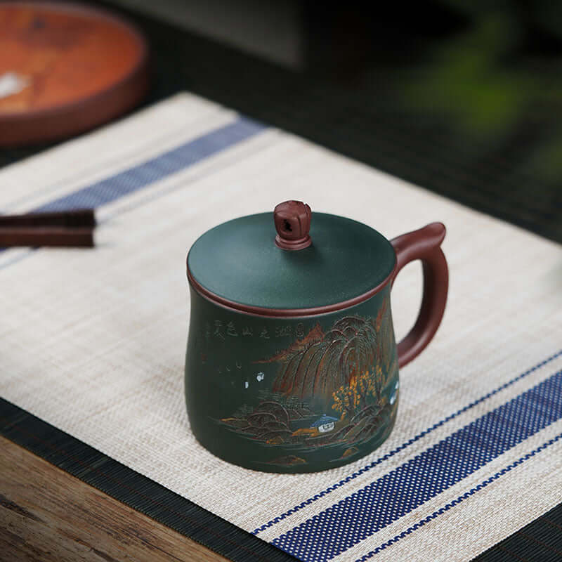 Handmade Yixing purple sand tea cup with mountain scenery, perfect for office use, large capacity, original craftsman design.