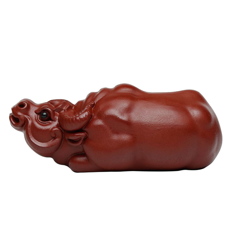 Handmade Yixing purple sand tea pet in the shape of a cattle, ideal for tea ceremonies and home decor.