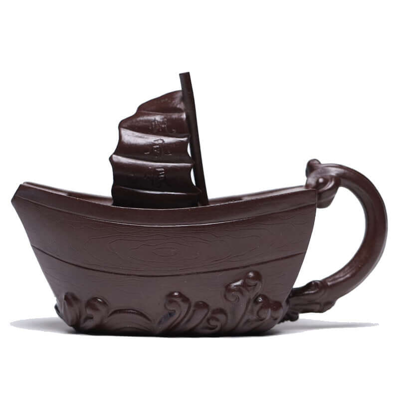 Handmade Yixing purple sand teapot shaped like a boat, showcasing unique craftsmanship and elegant design.
