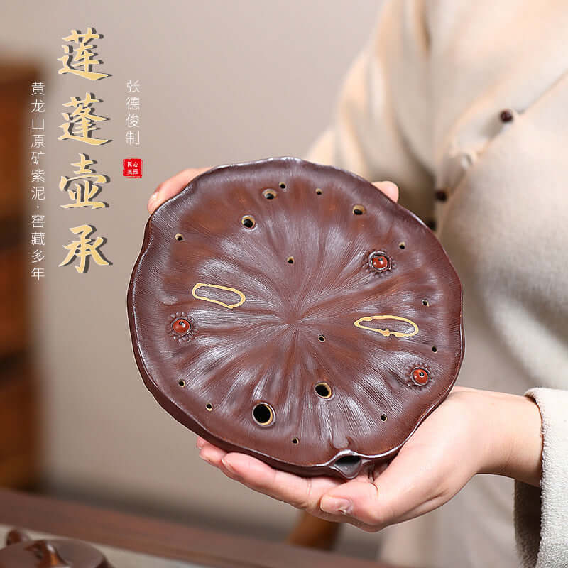 Handmade Yixing purple sand lotus pot bearing tea set accessory, showcasing intricate details and craftsmanship.
