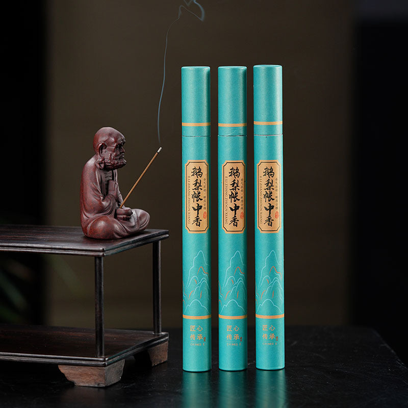 Handmade Yixing purple sand tea pet sculpture with incense holder, paired with decorative tea-themed scrolls.