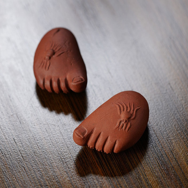 Handmade Yixing purple sand tea pet ornaments shaped like feet, ideal for tea lovers and enthusiasts.