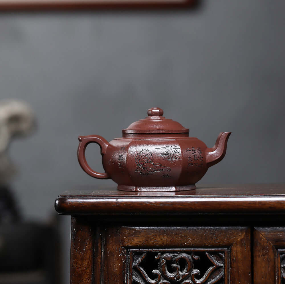 Handmade Yixing purple sand teapot with engraved design, perfect for a traditional kung fu tea set.
