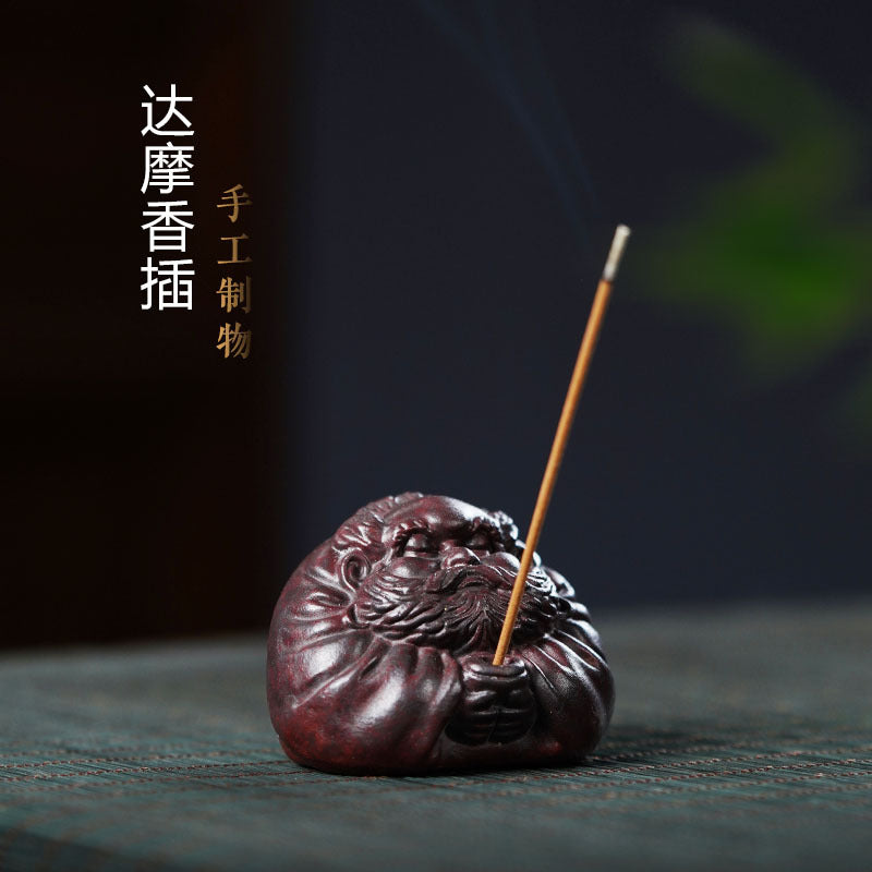 Handmade Yixing purple sand Daruma incense holder, beautifully carved for tea pet health. Unique gift for fitness enthusiasts.