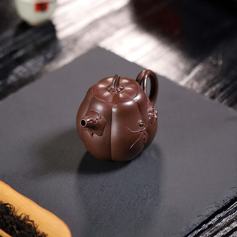 Handmade Yixing purple sand teapot in a pumpkin shape, crafted from original purple sand for home tea brewing.