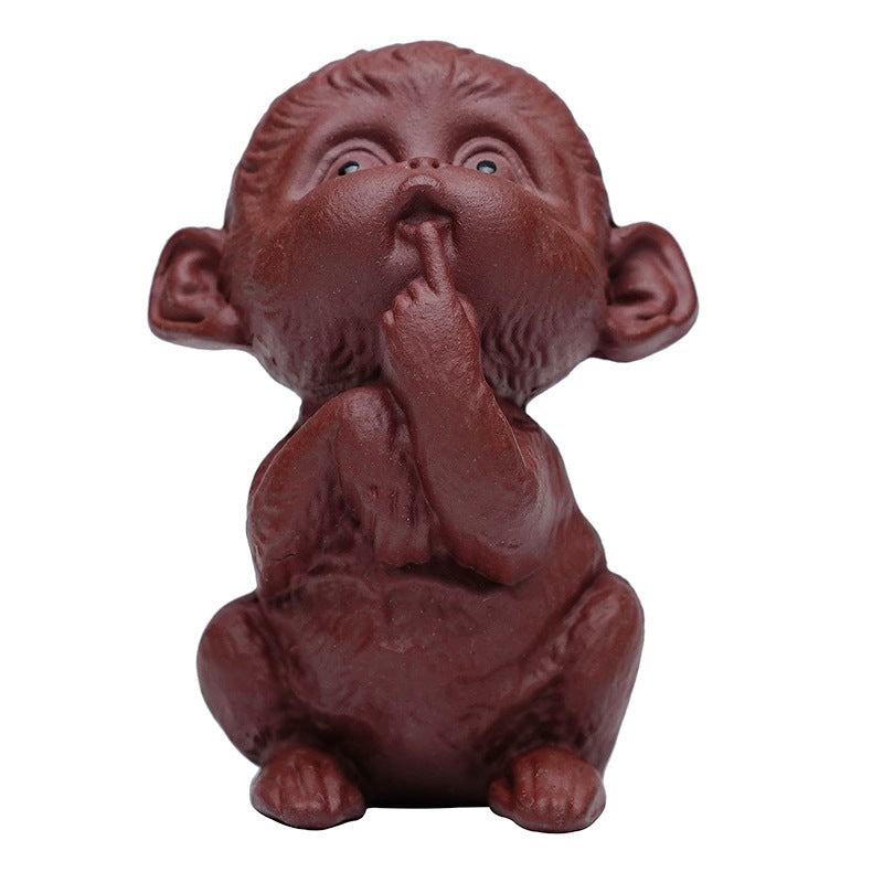 Handmade Yixing purple sand monkey sculpture, perfect for tea table decoration and tea pet collection.