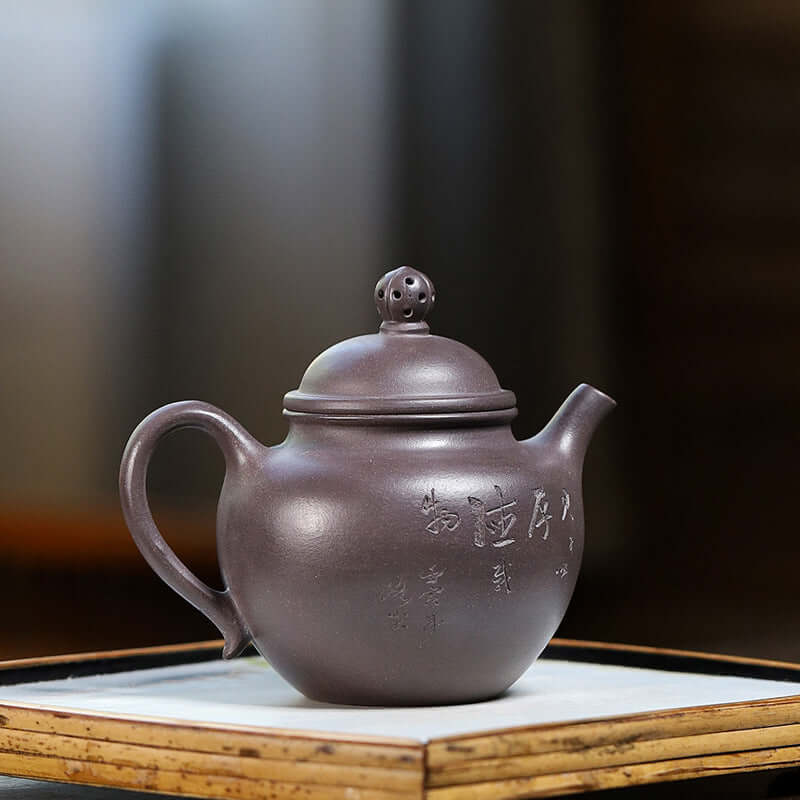 Handmade Yixing purple sand teapot with elegant design and fine craftsmanship.