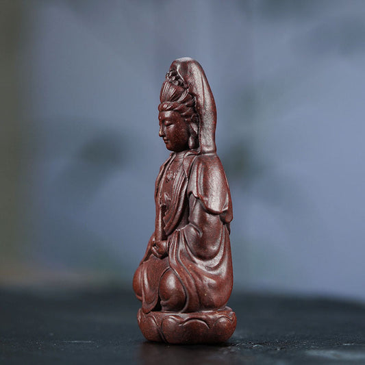 Handmade Yixing purple sand Guanyin sculpture, perfect for tea sets and home decor, showcasing traditional craftsmanship.