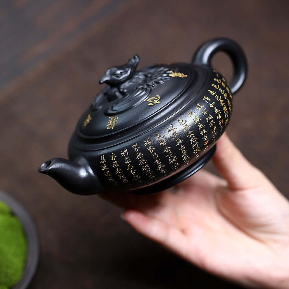 Handmade Yixing purple sand teapot with phoenix design, showcasing intricate gold inscriptions, perfect for home tea set.