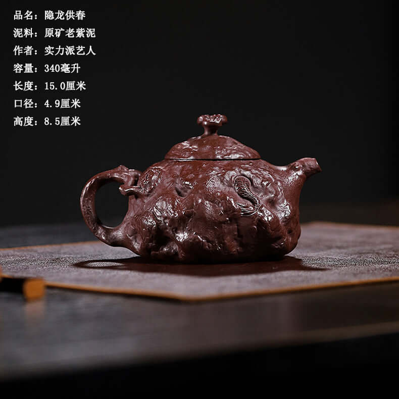 Handmade Yixing purple sand teapot with intricate design, crafted by skilled artisan, perfect for high-end tea set gifts.