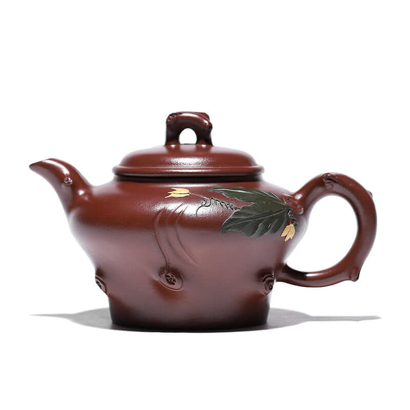 Handmade Yixing purple sand teapot with floral design, showcasing traditional craftsmanship and unique texture.