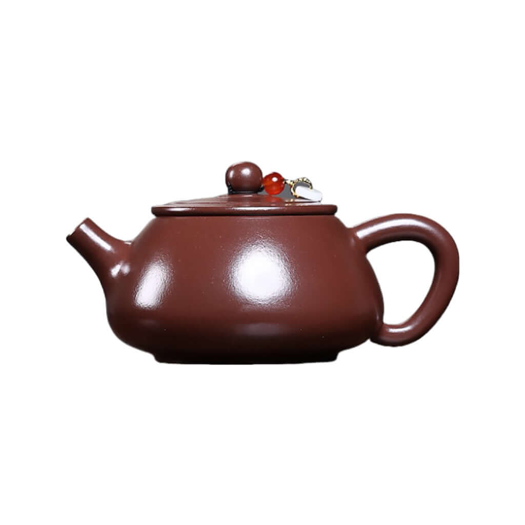 Handmade Yixing purple sand teapot with flat lid and stone scoop, perfect for Kung Fu tea brewing at home.