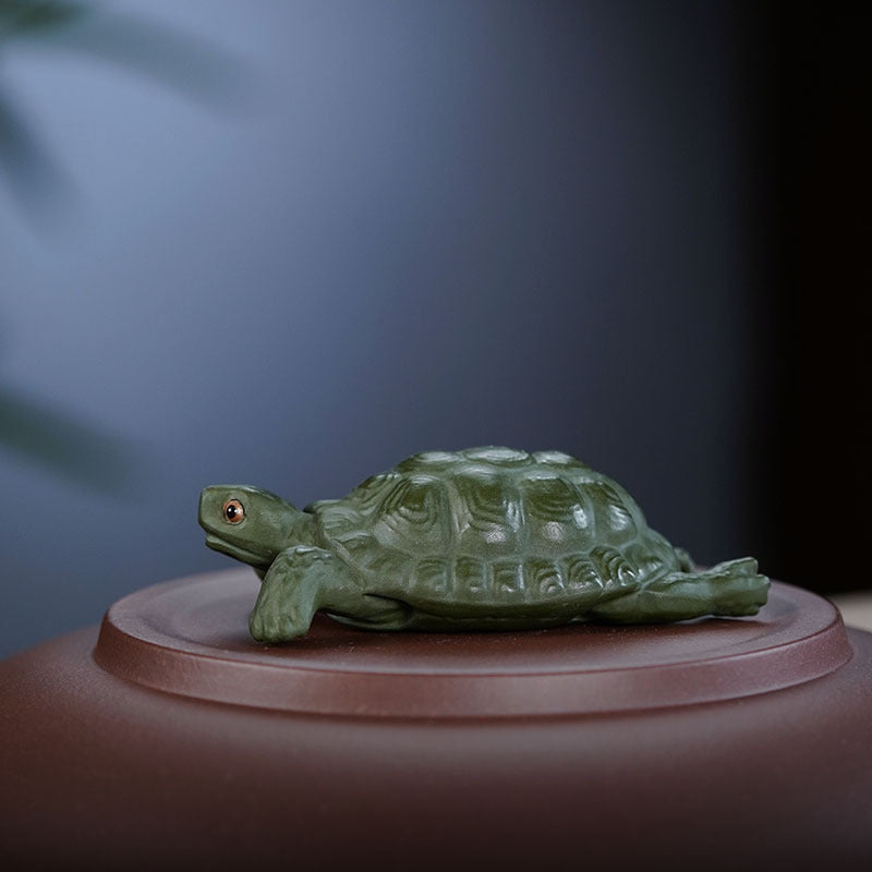 Handmade Yixing purple sand turtle sculpture, decorative tea pet for tea table, artisanal green mud craft.