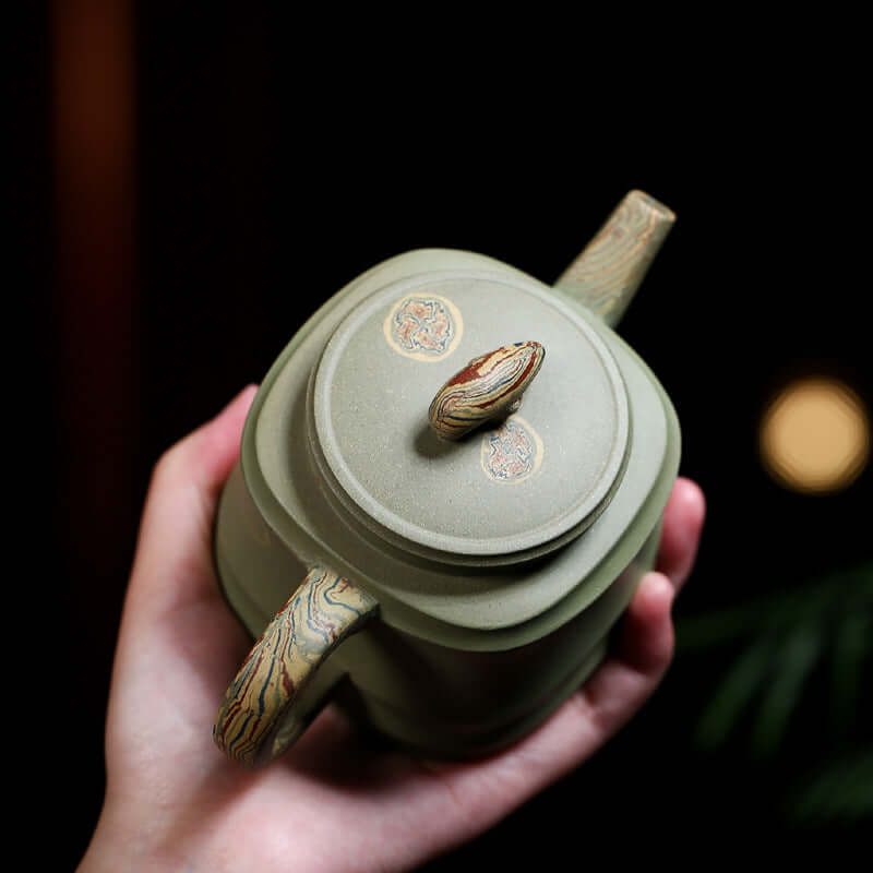 Handmade Yixing purple sand teapot with a unique twisted handle and elegant design, perfect for kung fu tea.
