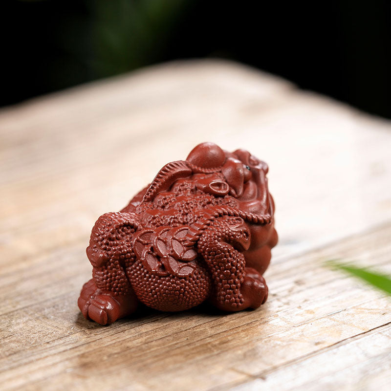 Handmade Yixing purple sand tea pet ornament featuring a detailed frog design, perfect for tea enthusiasts.