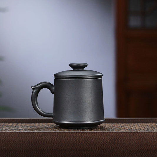 Handmade Yixing purple sand teacup, black mud kiln design, perfect for tea lovers and holiday gifts.