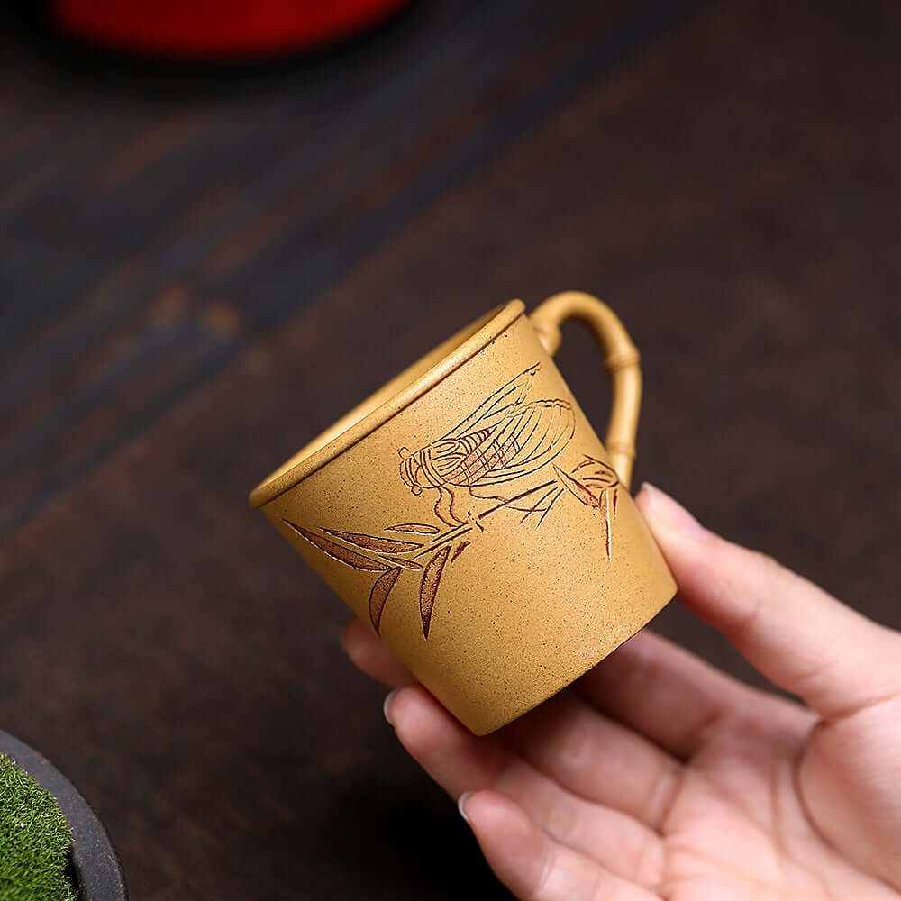 Handmade Yixing purple sand tea cup with bamboo carving, perfect for kung fu tea set, showcasing original craftsmanship.