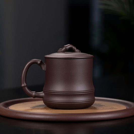 Handmade Yixing purple sand cup with bamboo design, ideal for tea, showcasing authentic craftsmanship and original materials.