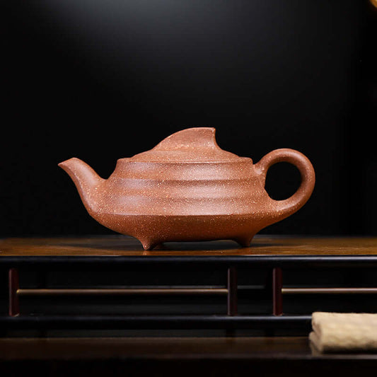 Handmade Yixing purple sand teapot showcasing intricate craftsmanship and original coarse sand texture.