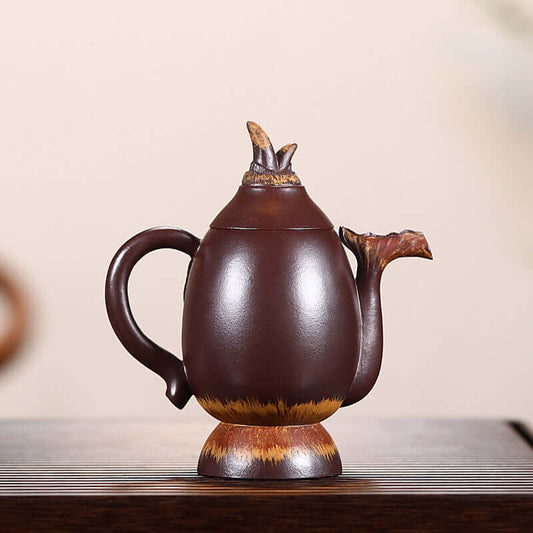 Handmade Yixing purple sand teapot with a unique design, ideal for tea brewing and serving.