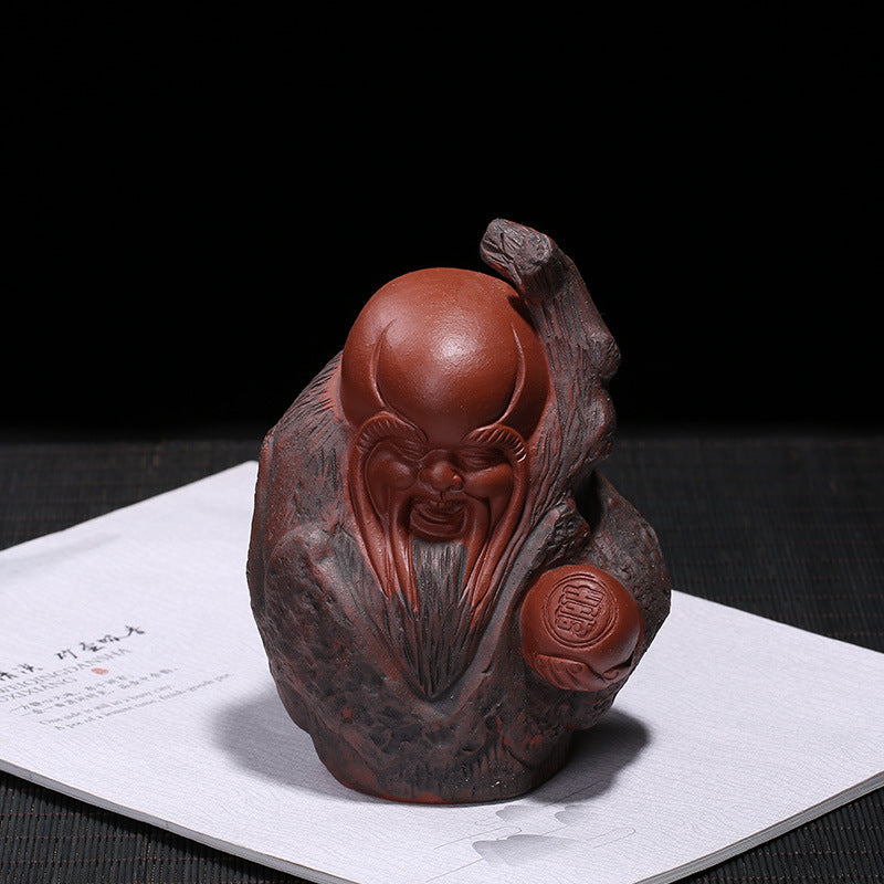 Handmade Yixing purple sand tea pet figure depicting a wise man, perfect for tea tray decoration or as a unique birthday gift.
