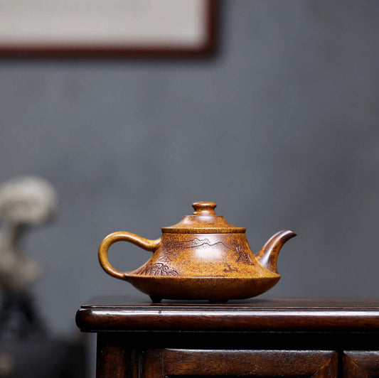 Handmade Yixing purple sand teapot with mountain design, showcasing the artistry of traditional Chinese craftsmanship.