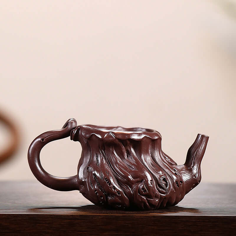 Handmade Yixing purple sand tea pot designed to resemble ancient wood, showcasing intricate craftsmanship.