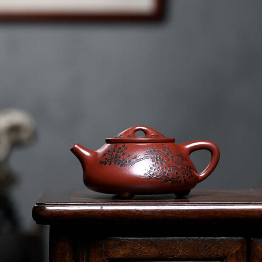 Handmade Yixing purple sand teapot with floral design, perfect for kung fu tea ceremonies.