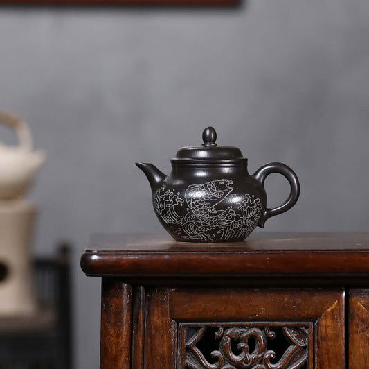 Handmade Yixing purple sand teapot featuring fish design, perfect for Kung Fu tea sets.