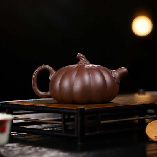 Handmade Yixing purple sand teapot in pumpkin shape, crafted from original purple sand, perfect for tea brewing.