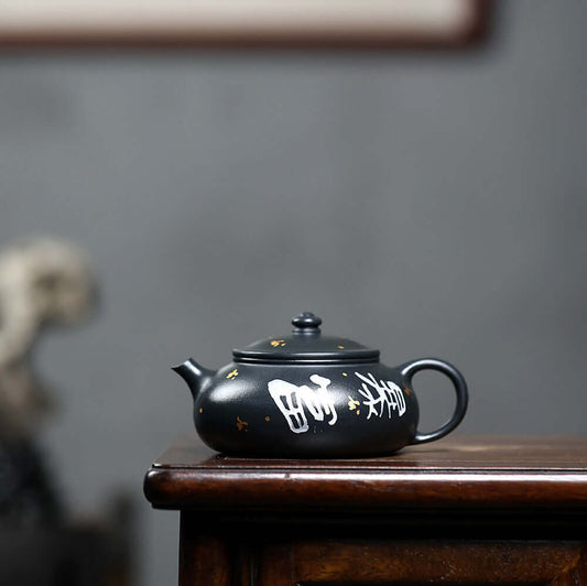 Handmade Yixing purple sand teapot in black with white inscriptions, ideal for home kung fu tea sets.