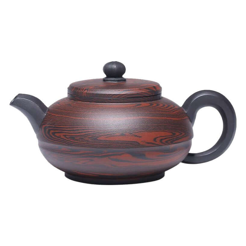 Handmade Yixing purple sand teapot with intricate wood-like patterns and a traditional silhouette.