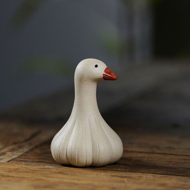 Handmade Yixing purple sand tea pet ornament in the shape of a goose, perfect for tea table decoration.