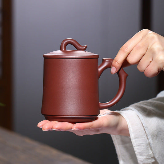 Handmade Yixing purple sand cup with creative lid and handle design, showcasing unique craftsmanship and elegant style.