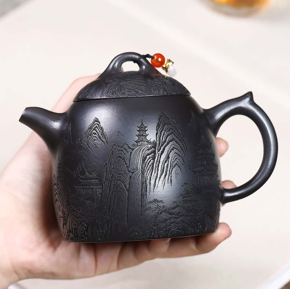 Handmade Yixing purple sand teapot featuring intricate mountain design, perfect for Kung Fu tea ceremonies.