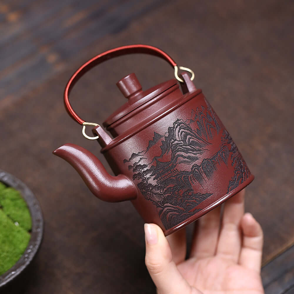 Handmade Yixing purple sand teapot featuring dragon blood sand and mountain scenery, perfect for kung fu tea sets.