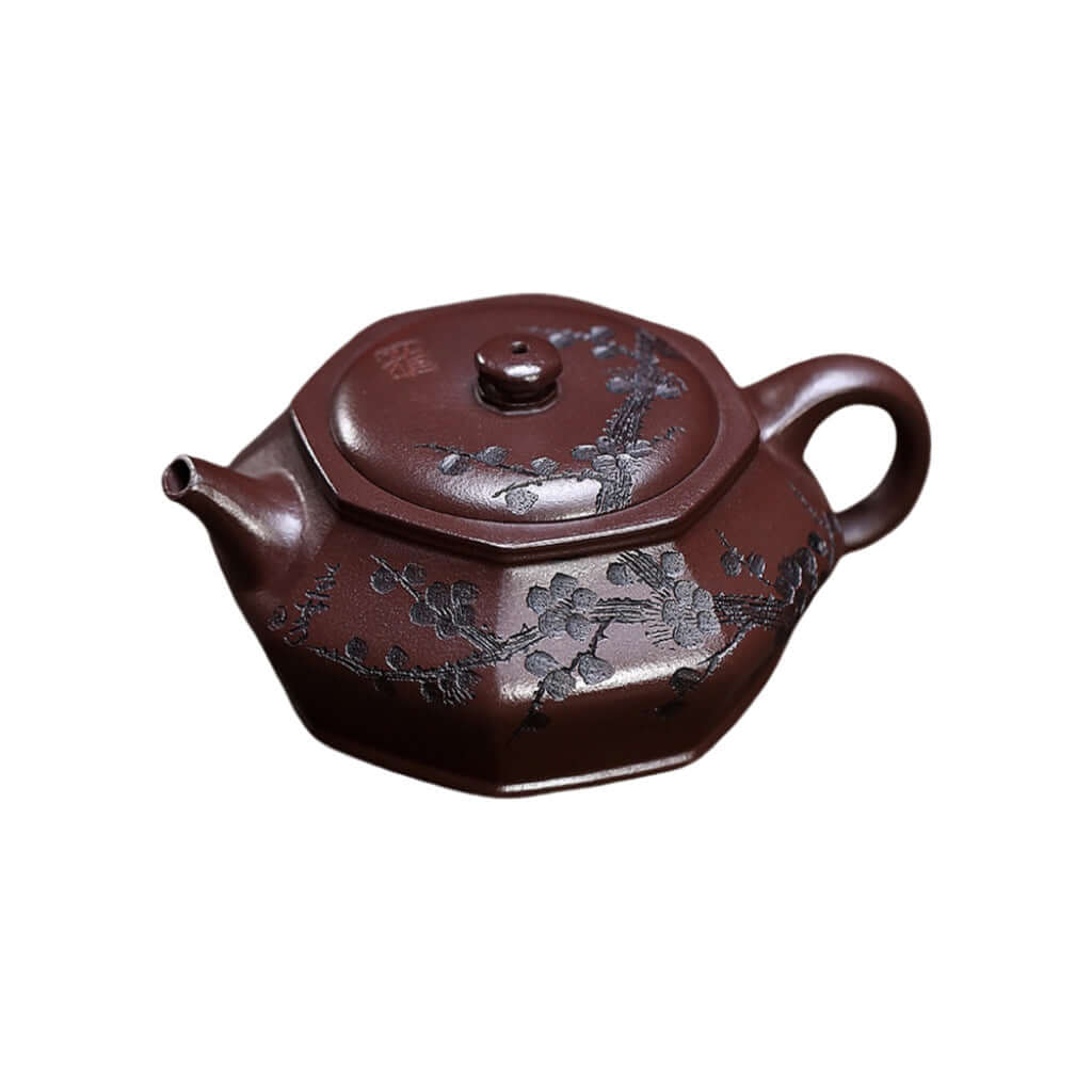 Handmade Yixing purple sand teapot with engraved plum blossoms, showcasing unique craftsmanship and original purple mud design.