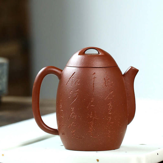 Handmade Yixing purple sand teapot with elegant inscriptions and a traditional design, perfect for kung fu tea.