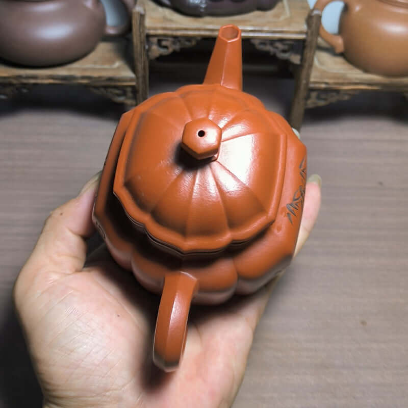 Handmade Yixing purple sand teapot with a unique pumpkin shape, showcasing craftsmanship and original material.