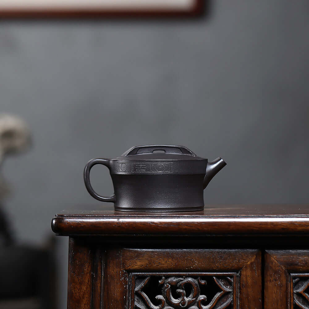 Handmade Yixing purple sand teapot displayed on a wooden table, showcasing unique craftsmanship and original materials.